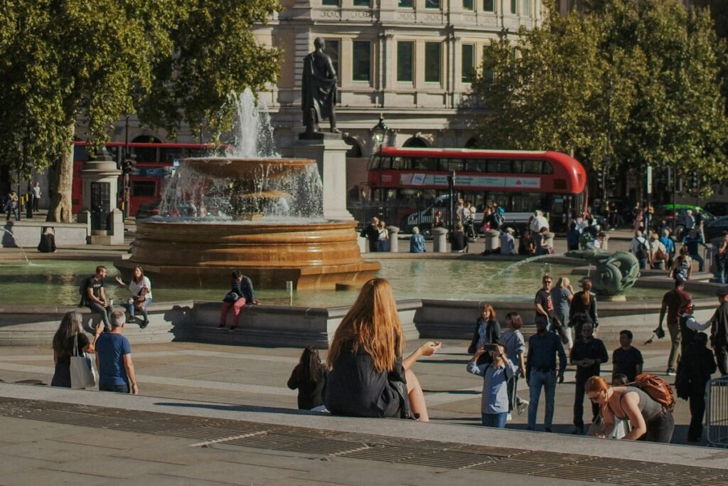 People relaxing by the fountains in Trafalgar Square, London